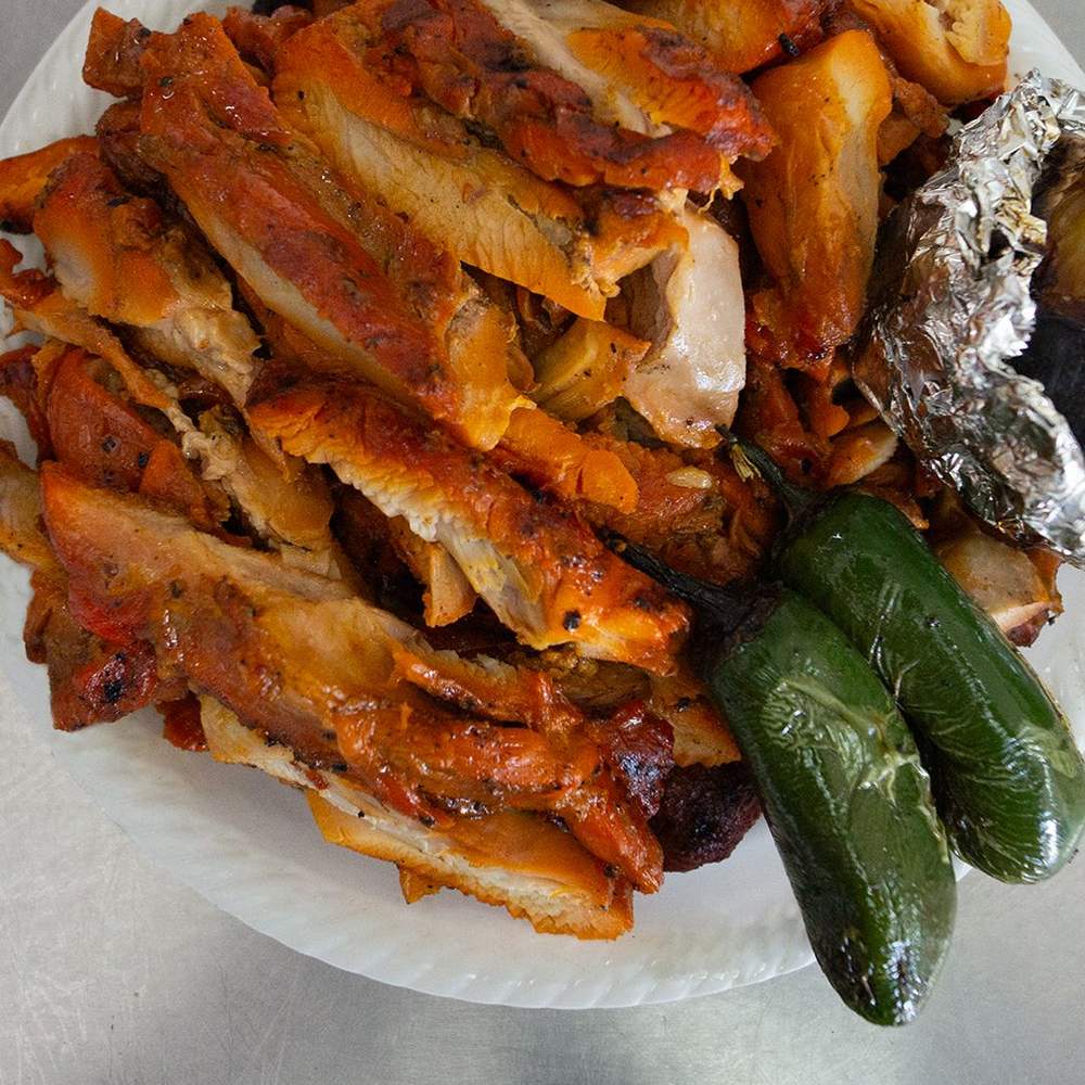 Pollo deshuesado con chiles toreados y cebolla sobre aluminio